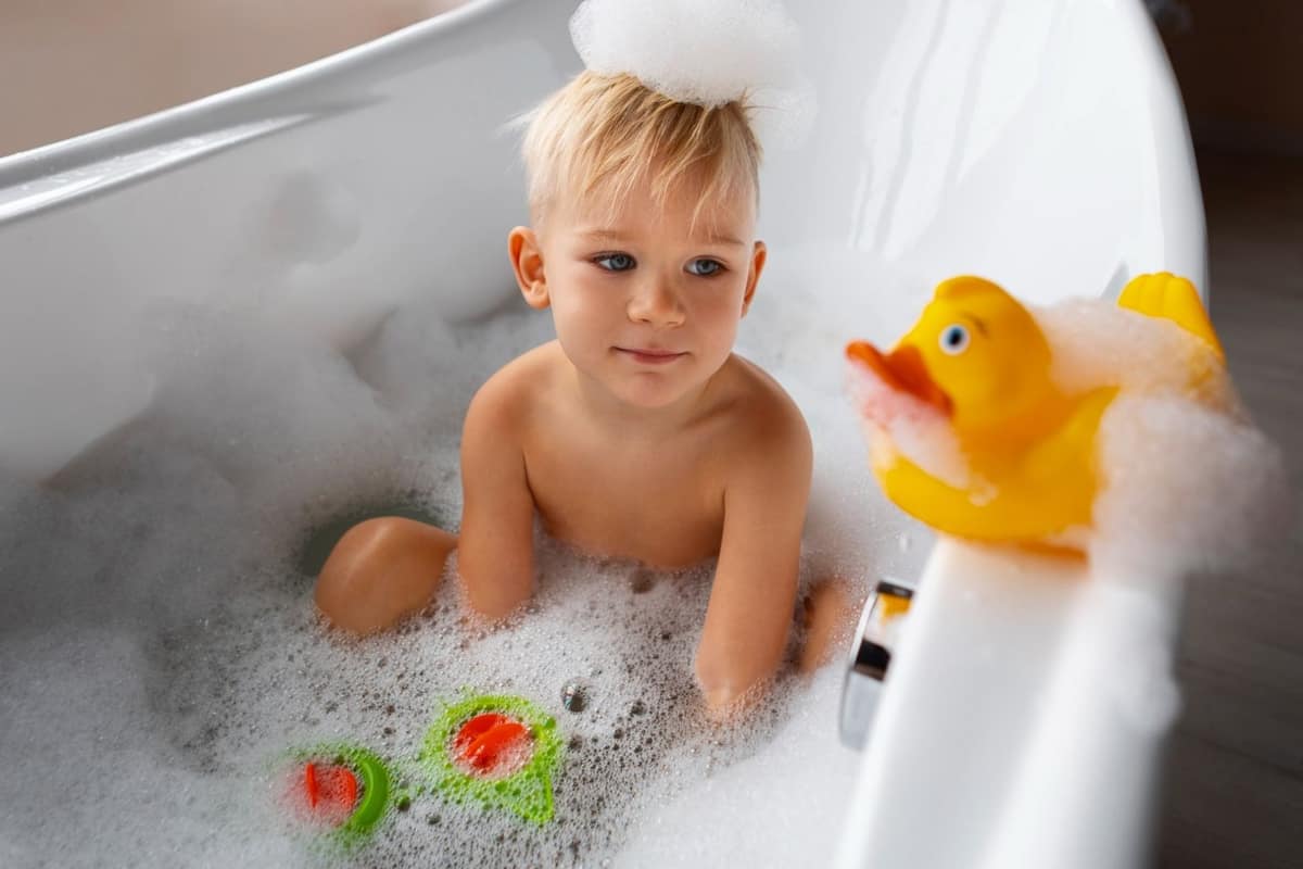 Baignoire préparée avec serviette, gobelets, thermomètre et tapis antidérapant