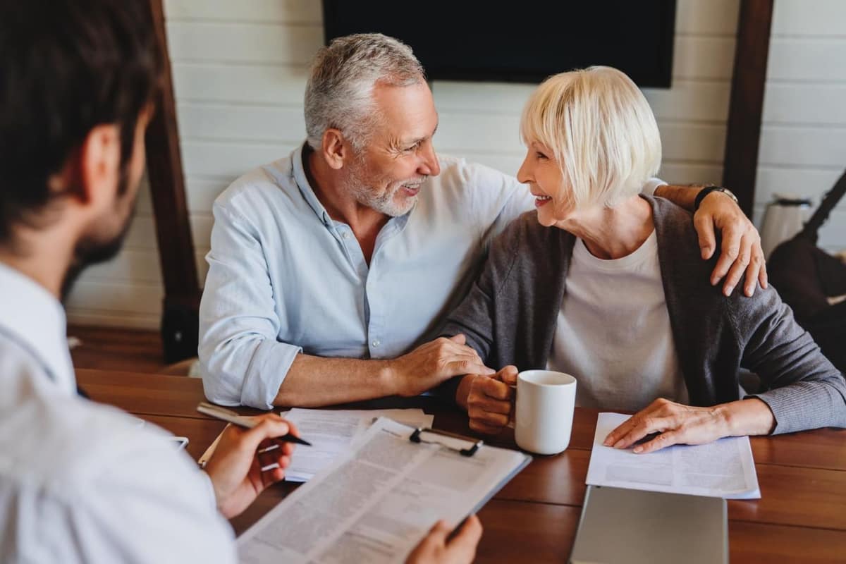 Dossier d’assurance vie, RIB et calculatrice sur une table en bois